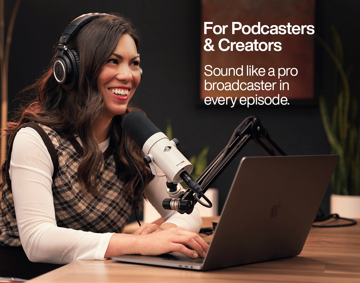 Podcaster speaking into a UA SD-1 broadcast-style microphone on a boom arm while working on a laptop, with text reading 'For Podcasters & Creators: Sound like a pro broadcaster in every episode'.